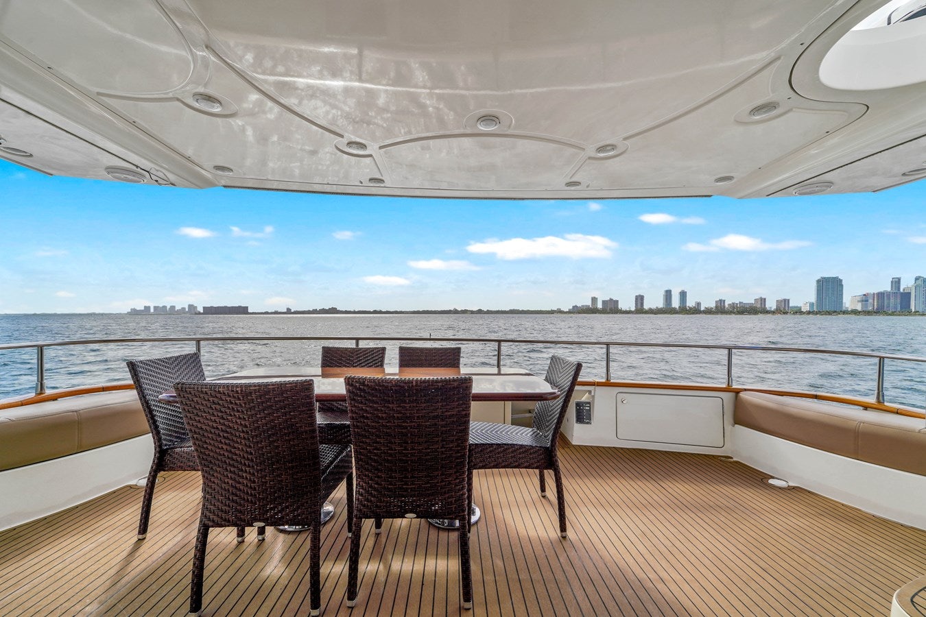 a table and chairs on a deck overlooking a body of water aboard AZIMUT 80 2003 Yacht for Sale