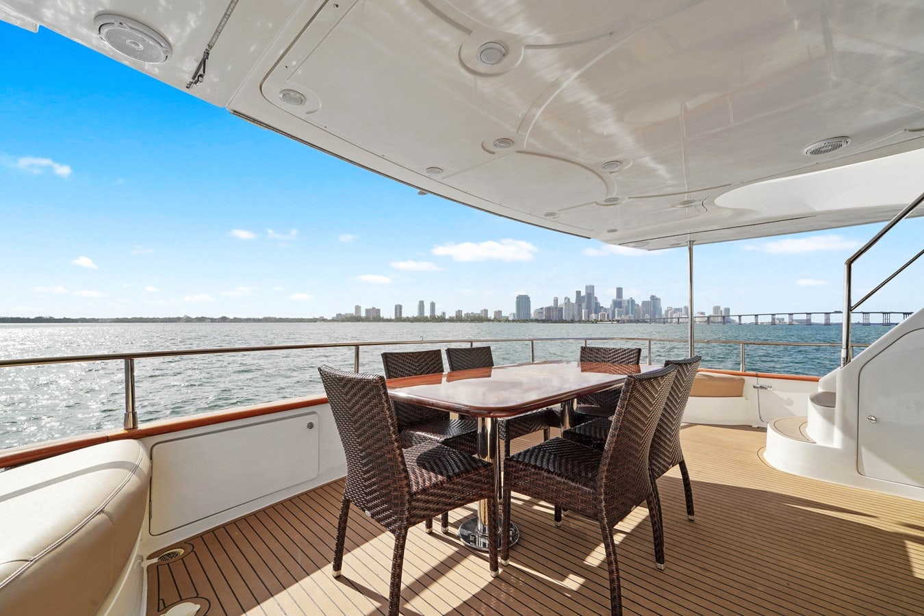 a table and chairs on a deck aboard AZIMUT 80 2003 Yacht for Sale