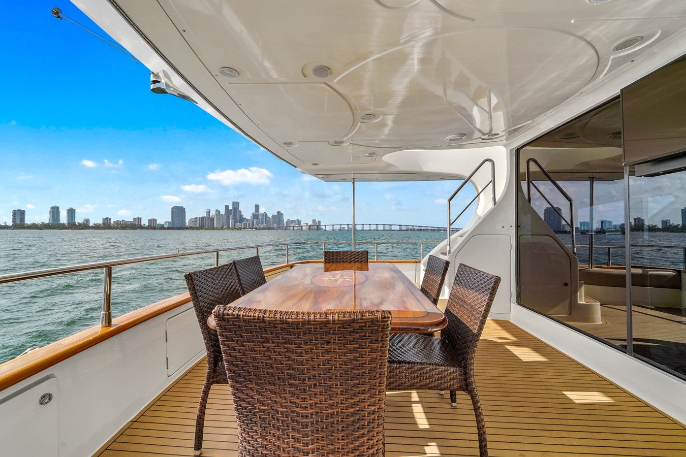 a table and chairs on a boat aboard AZIMUT 80 2003 Yacht for Sale