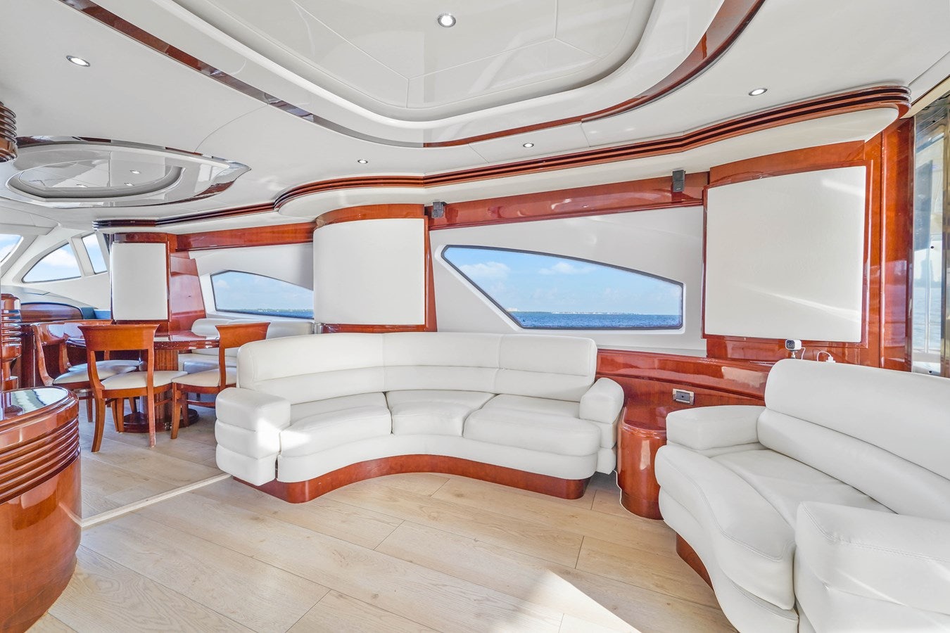 a room with a couch and a table and chairs aboard AZIMUT 80 2003 Yacht for Sale
