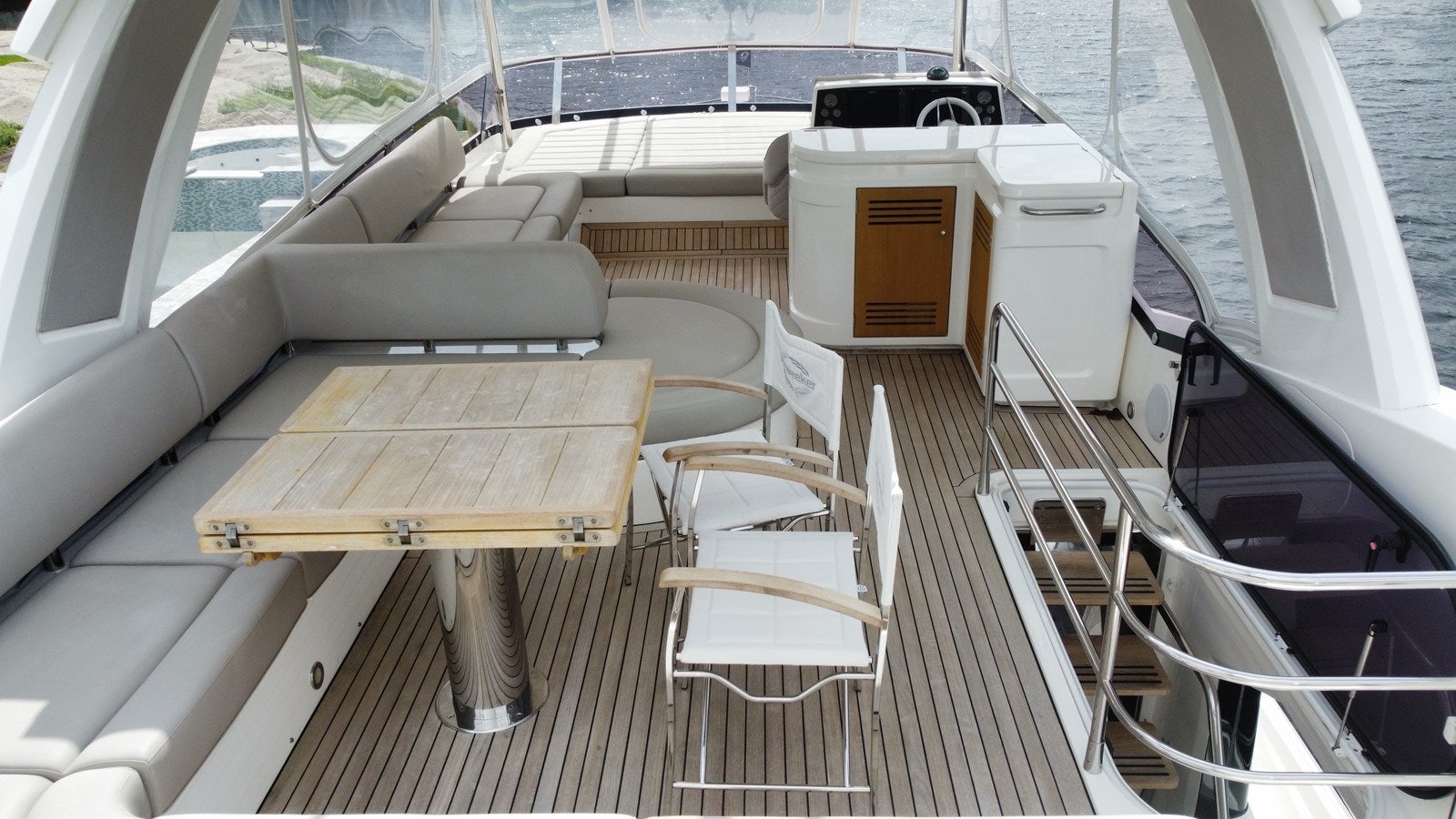 a deck with a table and chairs on it aboard 66 MANHATTAN Yacht for Sale