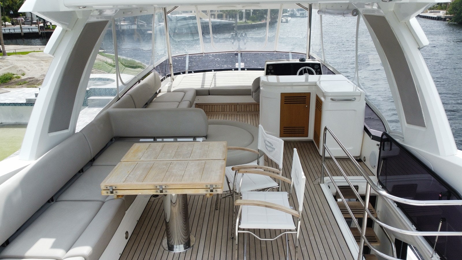 a deck with a table and chairs on it aboard 66 MANHATTAN Yacht for Sale