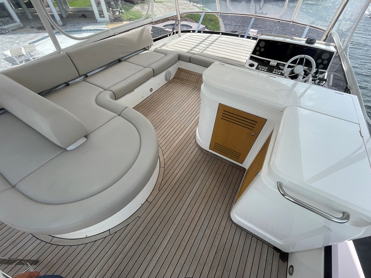 a room with a couch and a table with chairs aboard 66 MANHATTAN Yacht for Sale