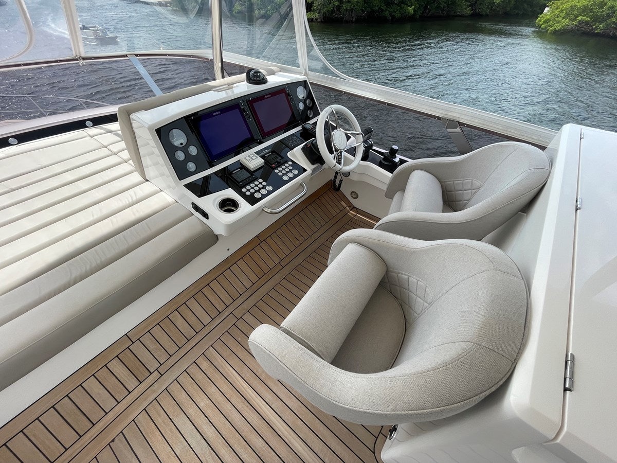 a boat with a steering wheel and a seat on the deck aboard 66 MANHATTAN Yacht for Sale