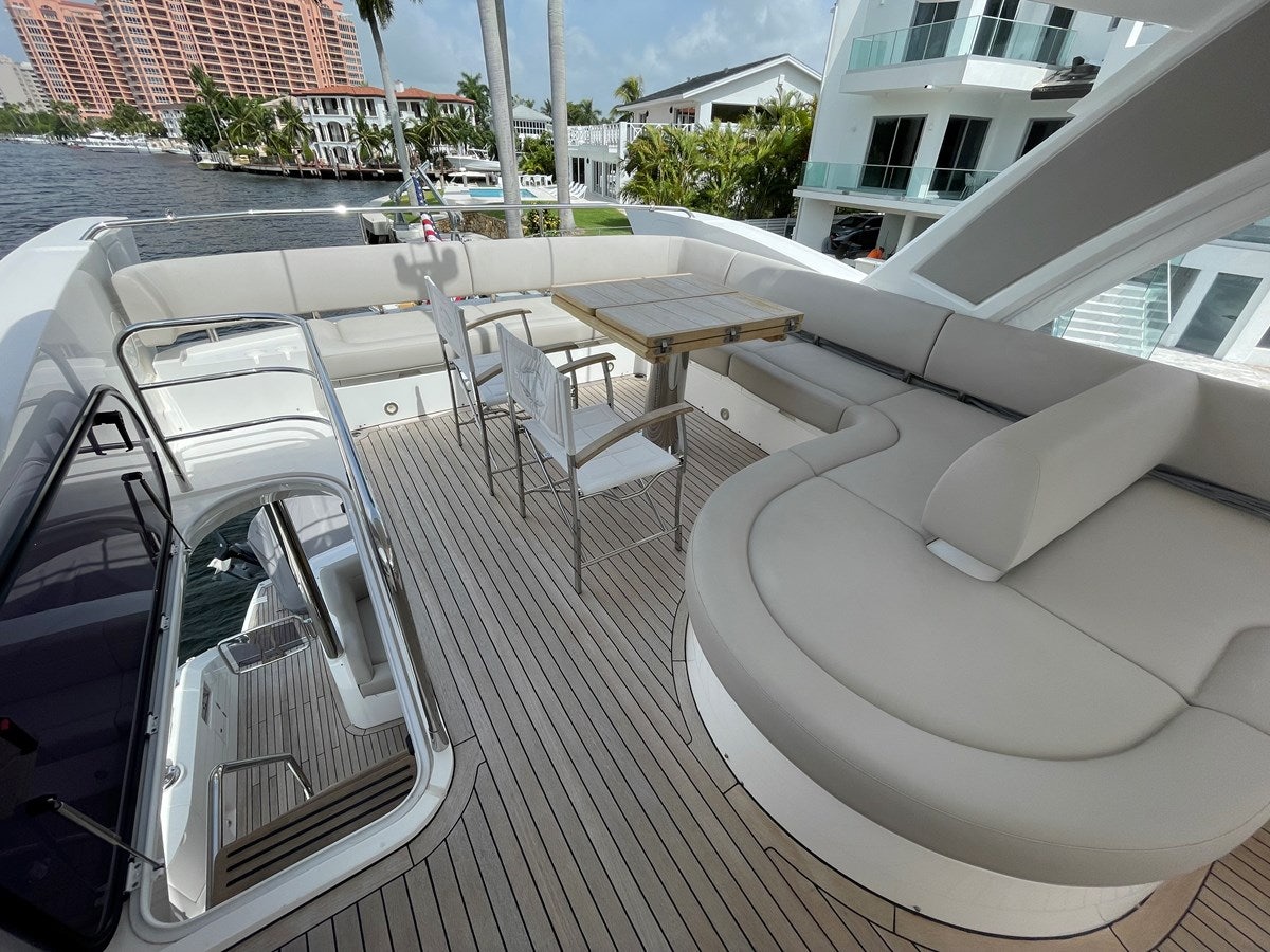 a deck with a table and chairs on it aboard 66 MANHATTAN Yacht for Sale