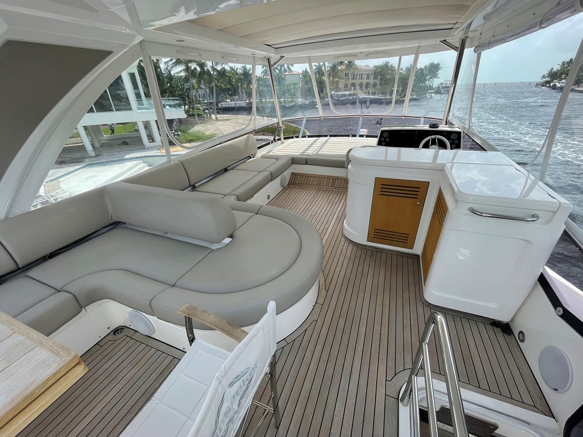 a room with a couch and a table with chairs aboard 66 MANHATTAN Yacht for Sale