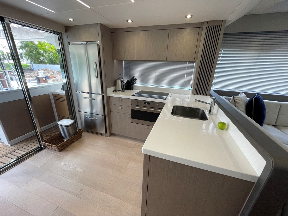 a kitchen with a sink and a refrigerator aboard 66 MANHATTAN Yacht for Sale