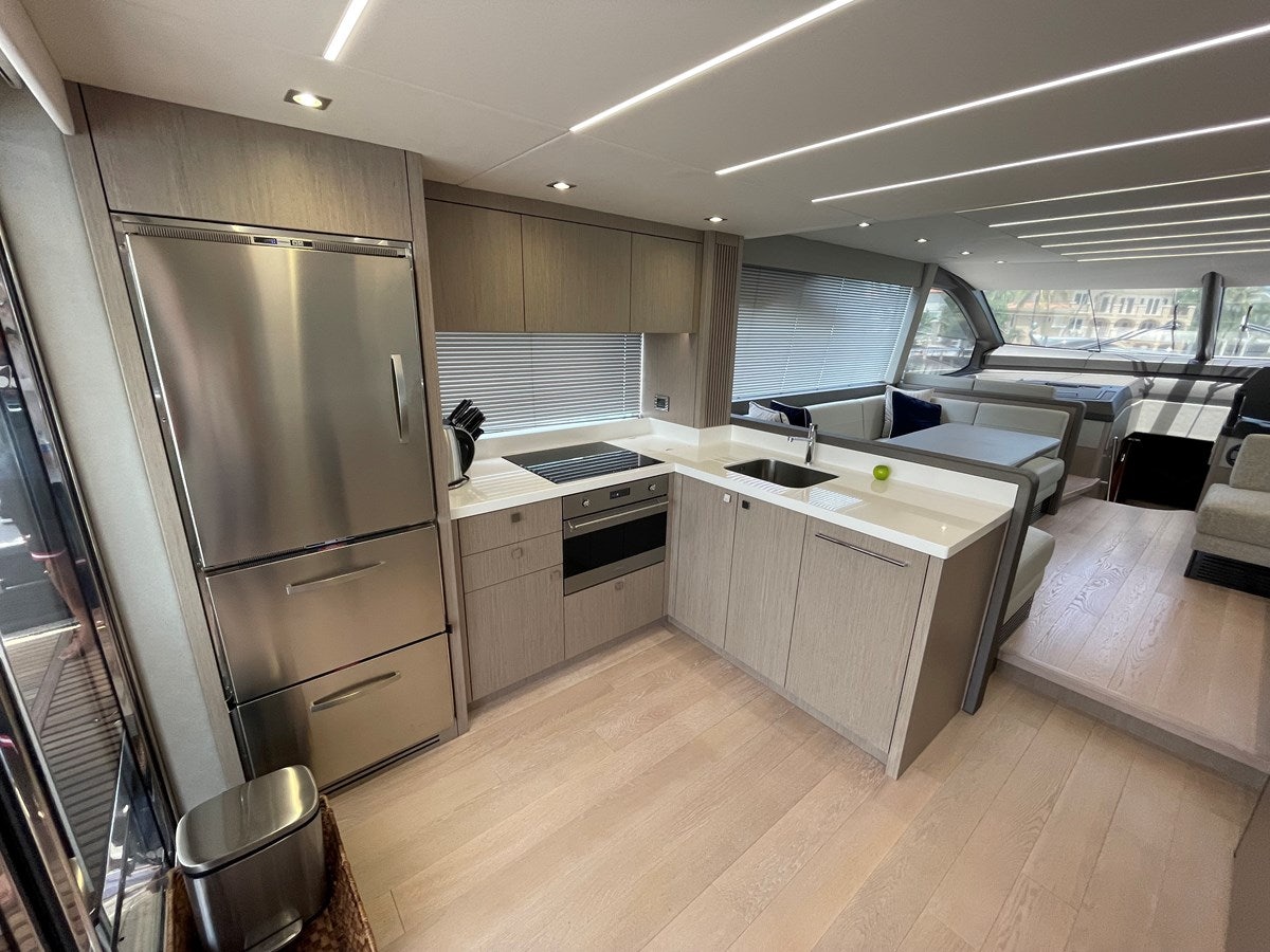 a kitchen with a large refrigerator aboard 66 MANHATTAN Yacht for Sale