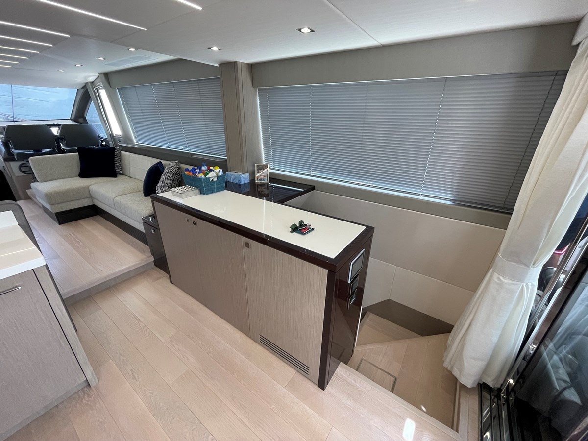 a room with a table and couches aboard 66 MANHATTAN Yacht for Sale