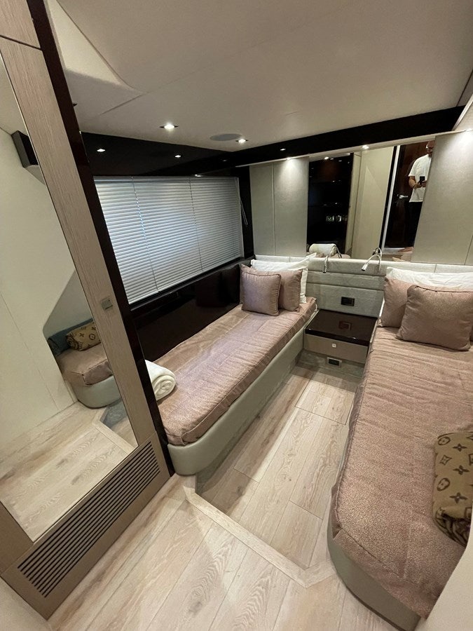 a room with a bed and a mirror aboard 66 MANHATTAN Yacht for Sale