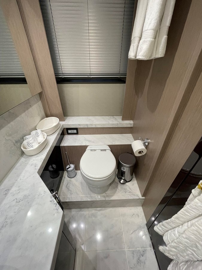 a bathroom with a toilet and a sink aboard 66 MANHATTAN Yacht for Sale