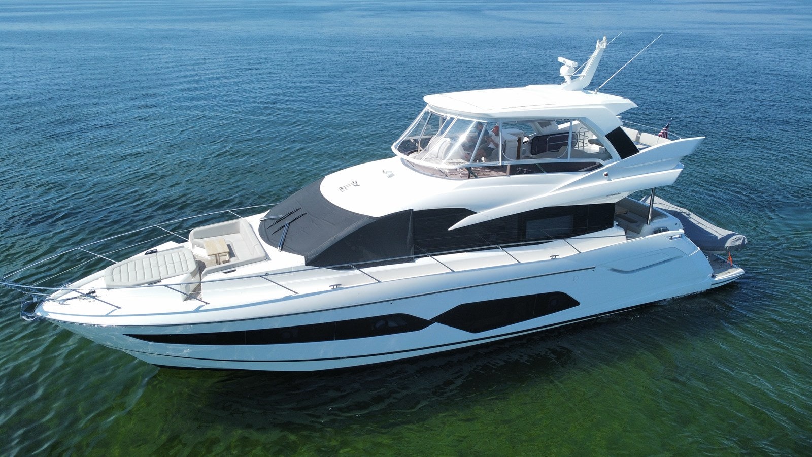 a white yacht on the water aboard 66 MANHATTAN Yacht for Sale