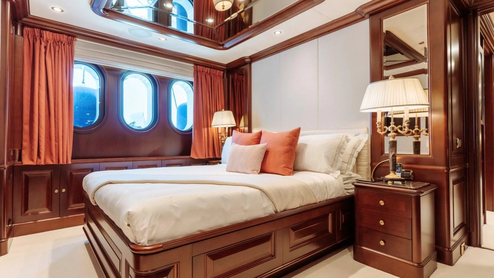 a bed with a white bed spread aboard INCAL Yacht for Sale