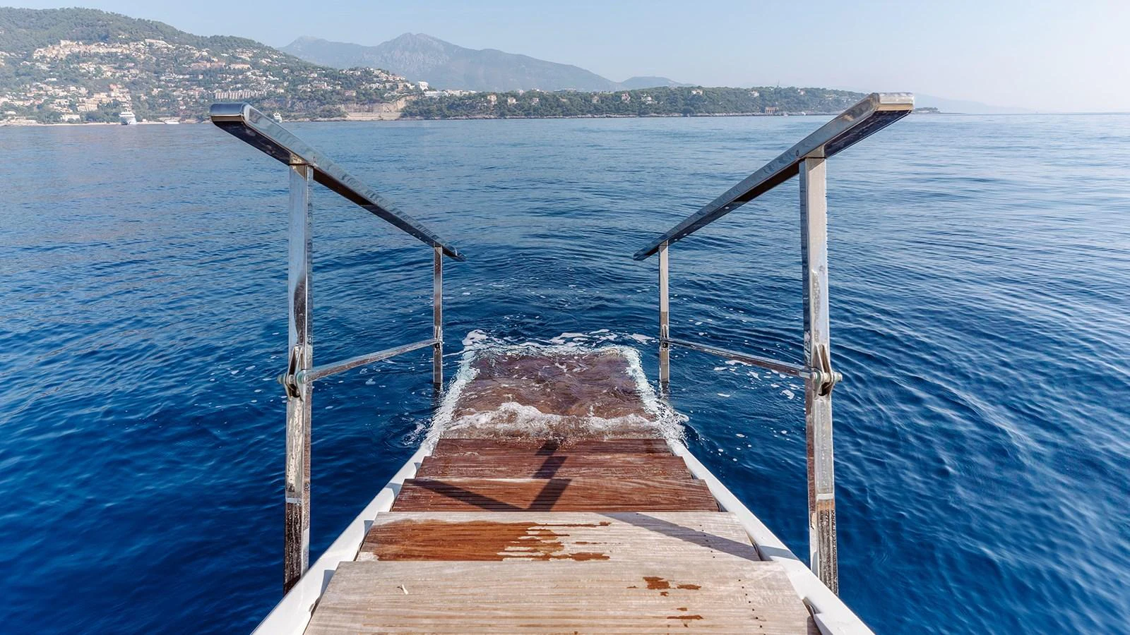 a wooden bridge over water aboard INCAL Yacht for Sale