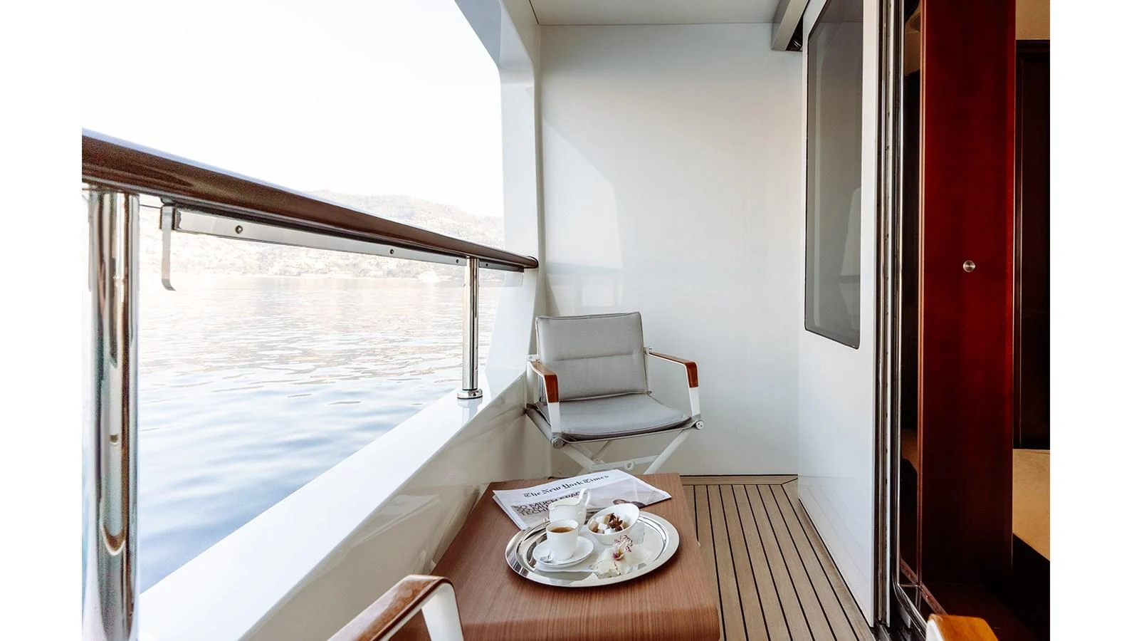 a table with a plate and a chair on it aboard INCAL Yacht for Sale