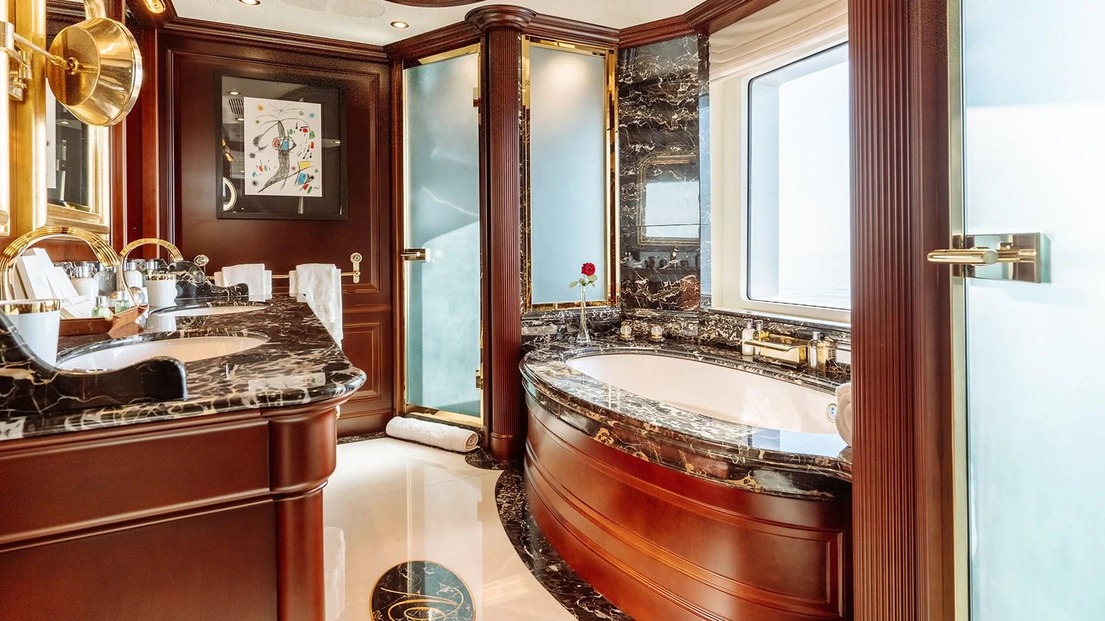 a bathroom with a tub sink and cabinets aboard INCAL Yacht for Sale