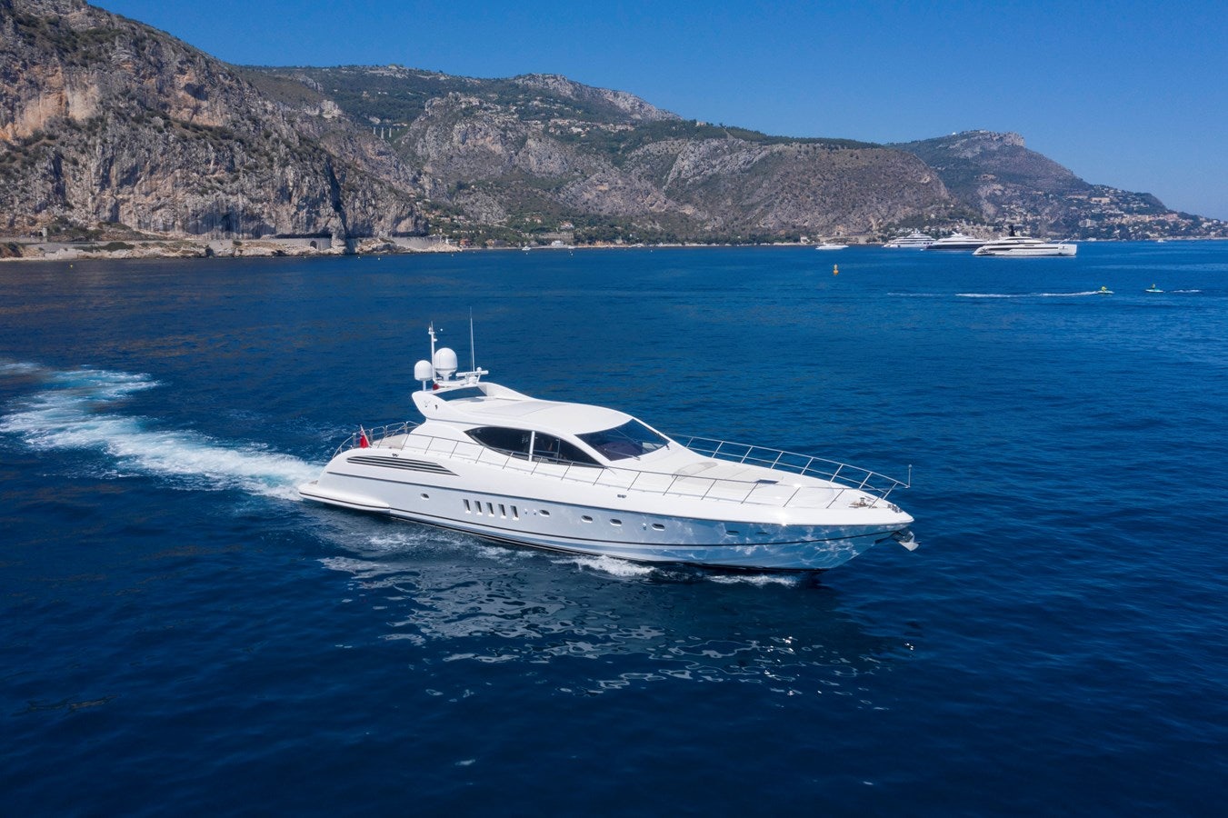 a white boat on the water aboard ULTIMA BEACH Yacht for Sale