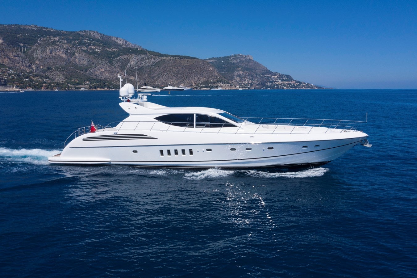 a white yacht on the water aboard ULTIMA BEACH Yacht for Sale