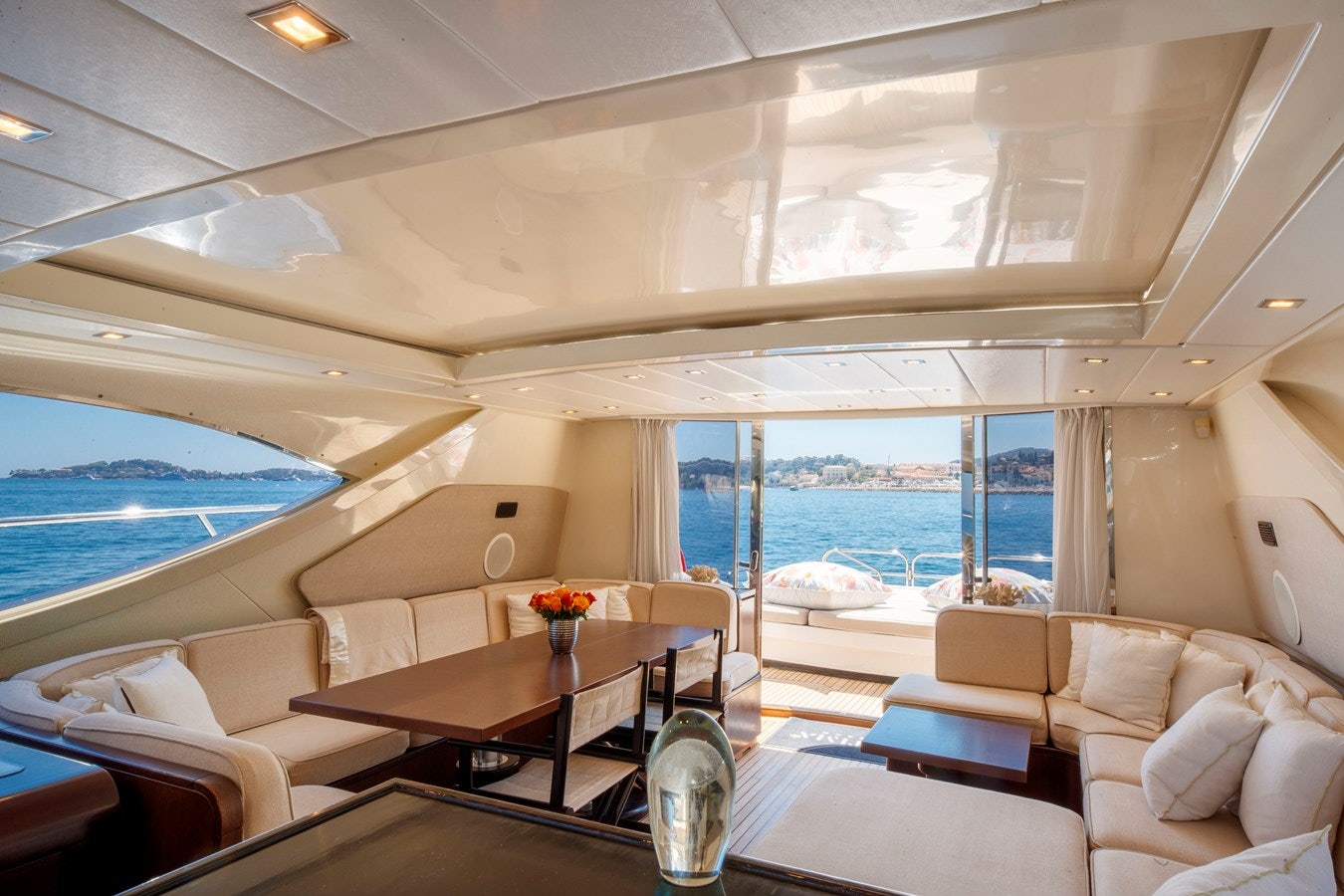 a room with a table and chairs aboard ULTIMA BEACH Yacht for Sale