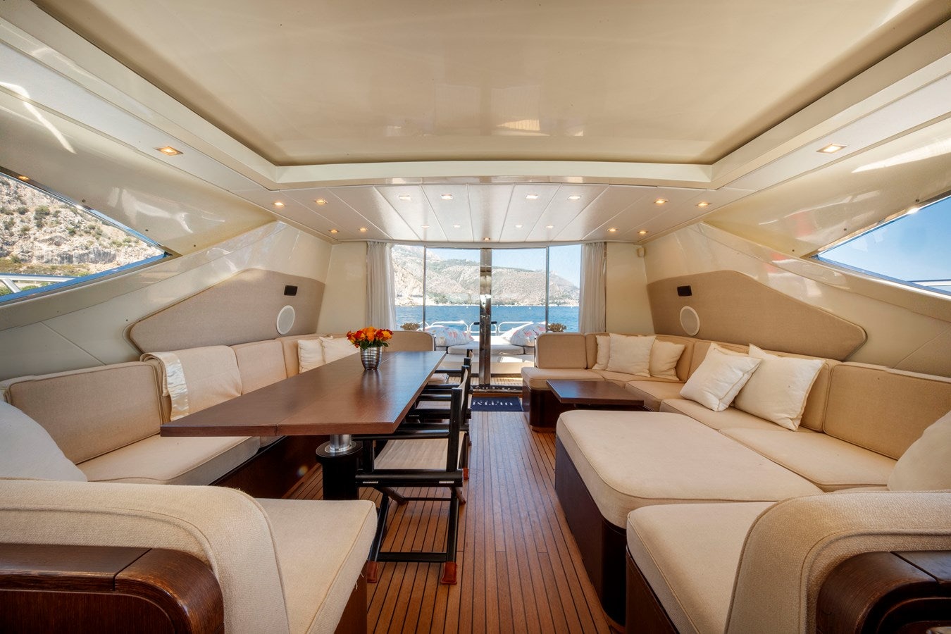 a room with a table and couches aboard ULTIMA BEACH Yacht for Sale