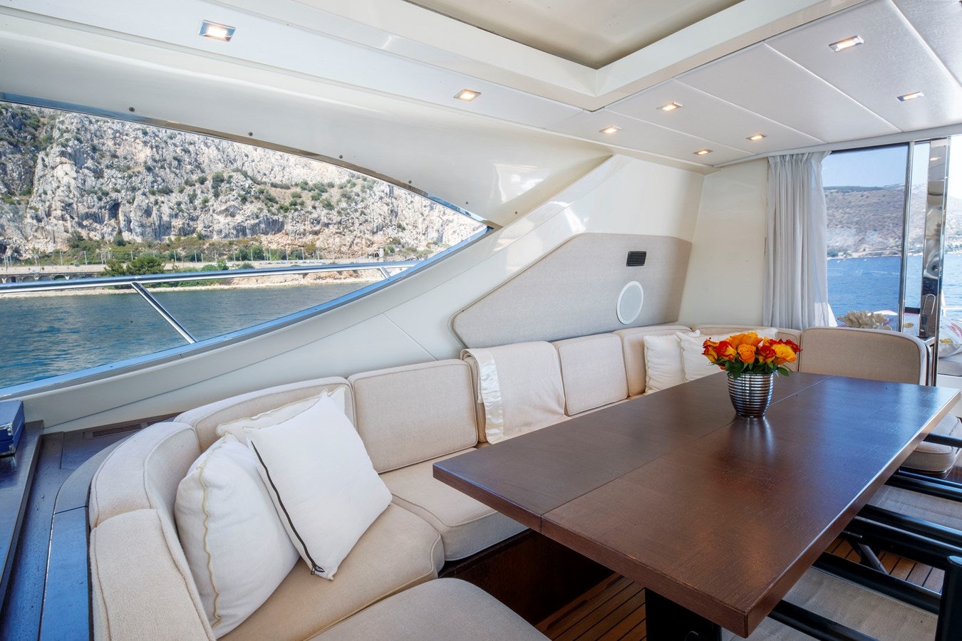 a room with a table and chairs aboard ULTIMA BEACH Yacht for Sale
