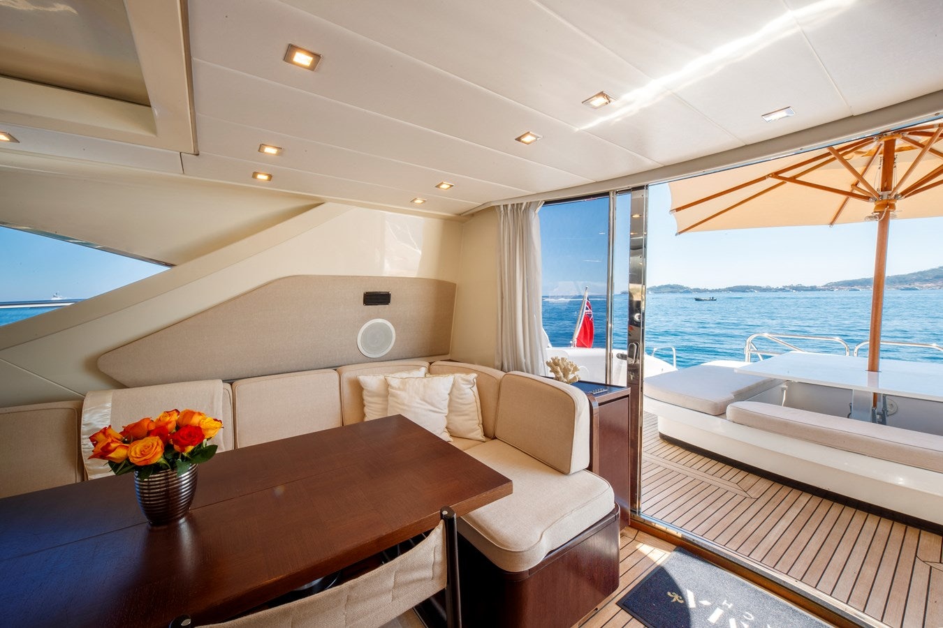 a room with a table and chairs aboard ULTIMA BEACH Yacht for Sale