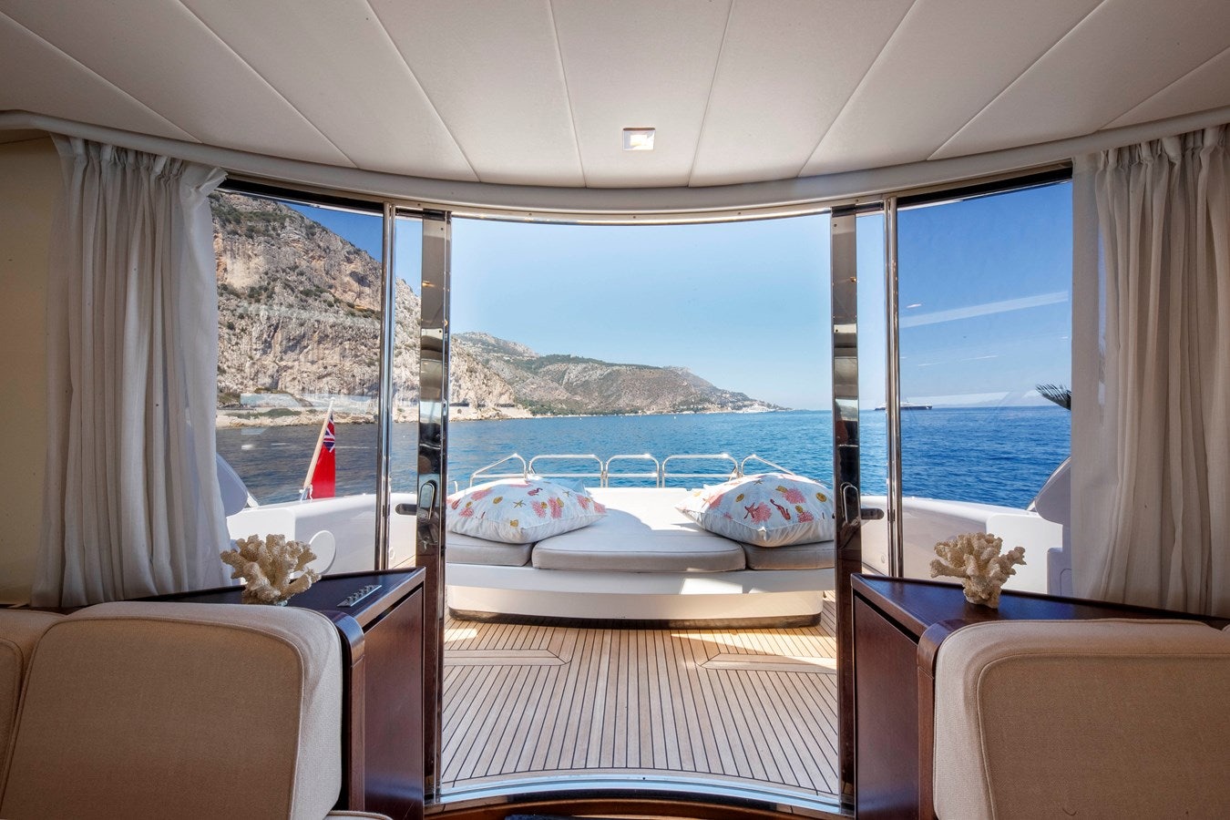 a room with a view of the ocean and mountains aboard ULTIMA BEACH Yacht for Sale