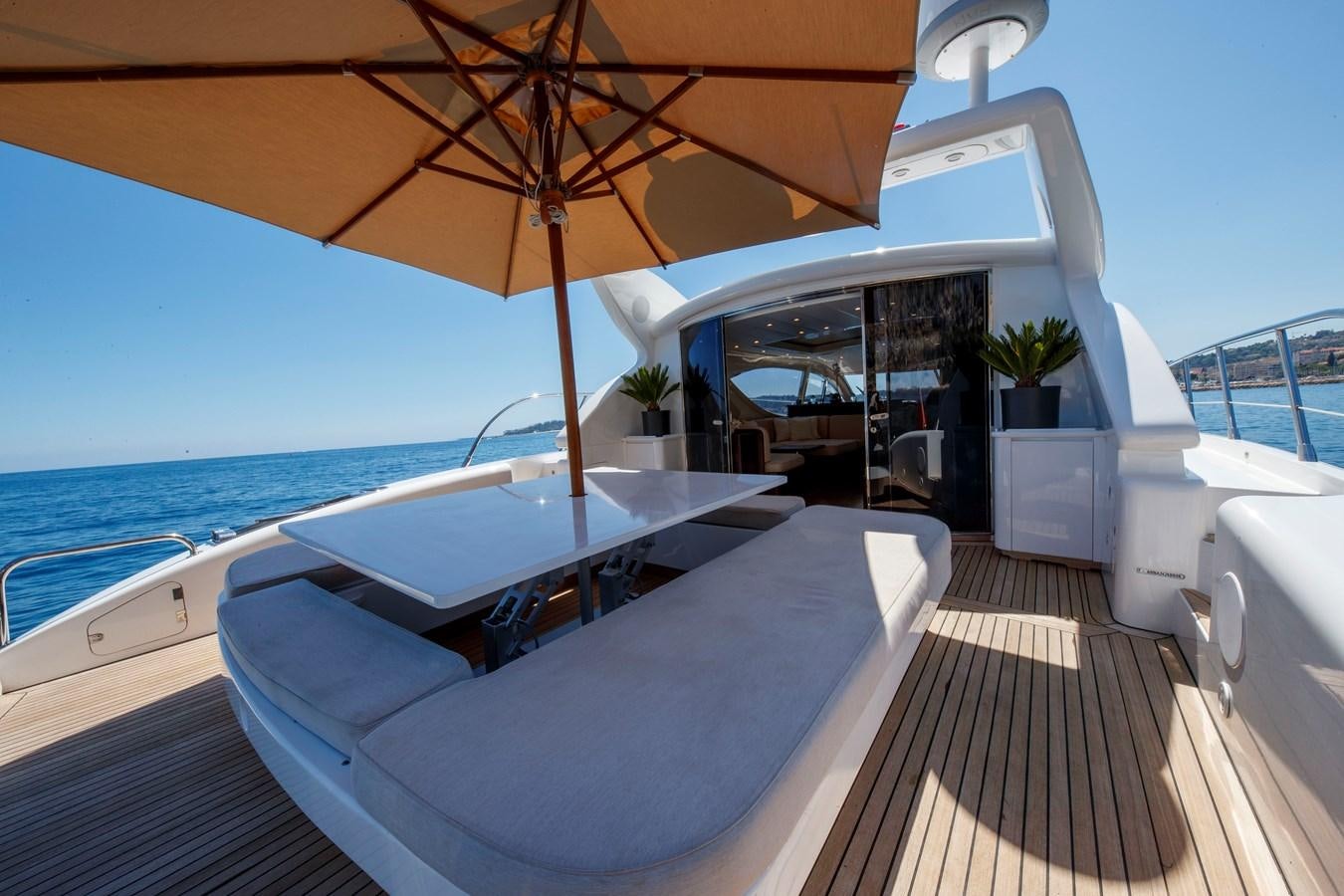 a pool with a table and umbrella aboard ULTIMA BEACH Yacht for Sale