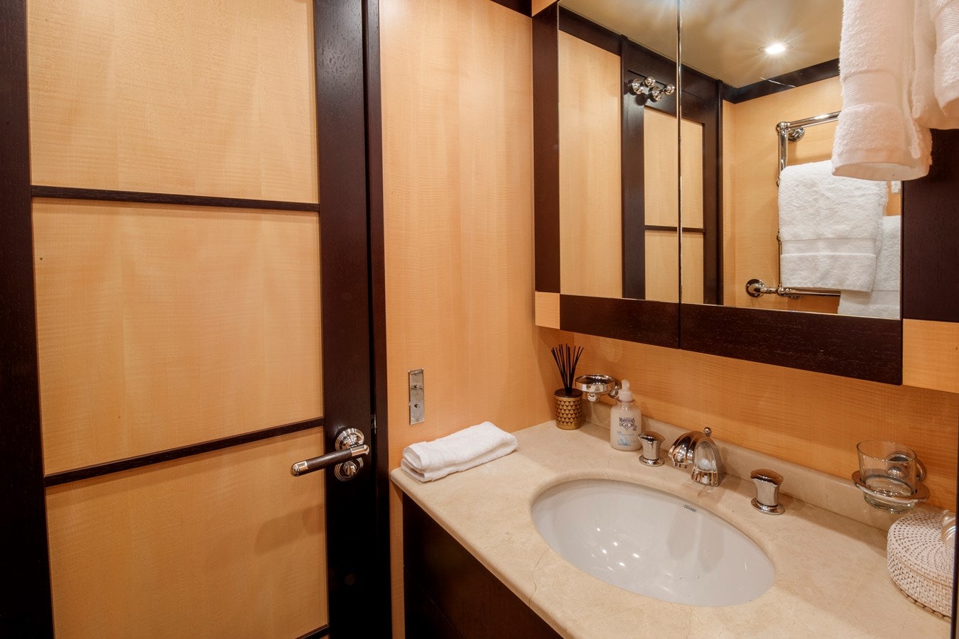 a bathroom with a sink and a mirror aboard ULTIMA BEACH Yacht for Sale