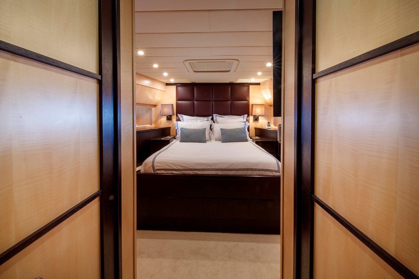 a room with a bed and a door aboard ULTIMA BEACH Yacht for Sale