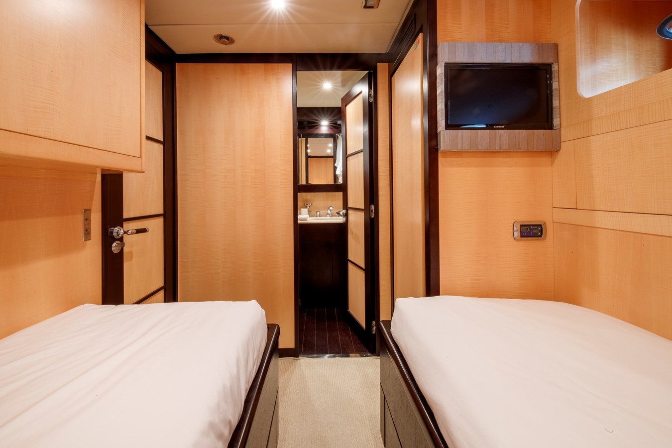a hotel room with a bed and tv aboard ULTIMA BEACH Yacht for Sale