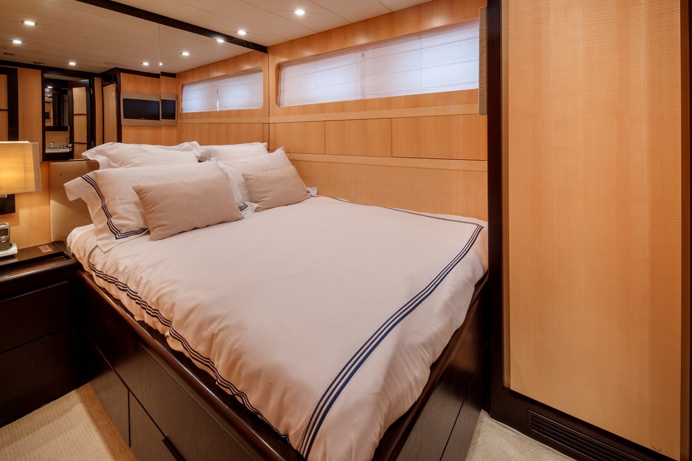 a bed with white sheets aboard ULTIMA BEACH Yacht for Sale