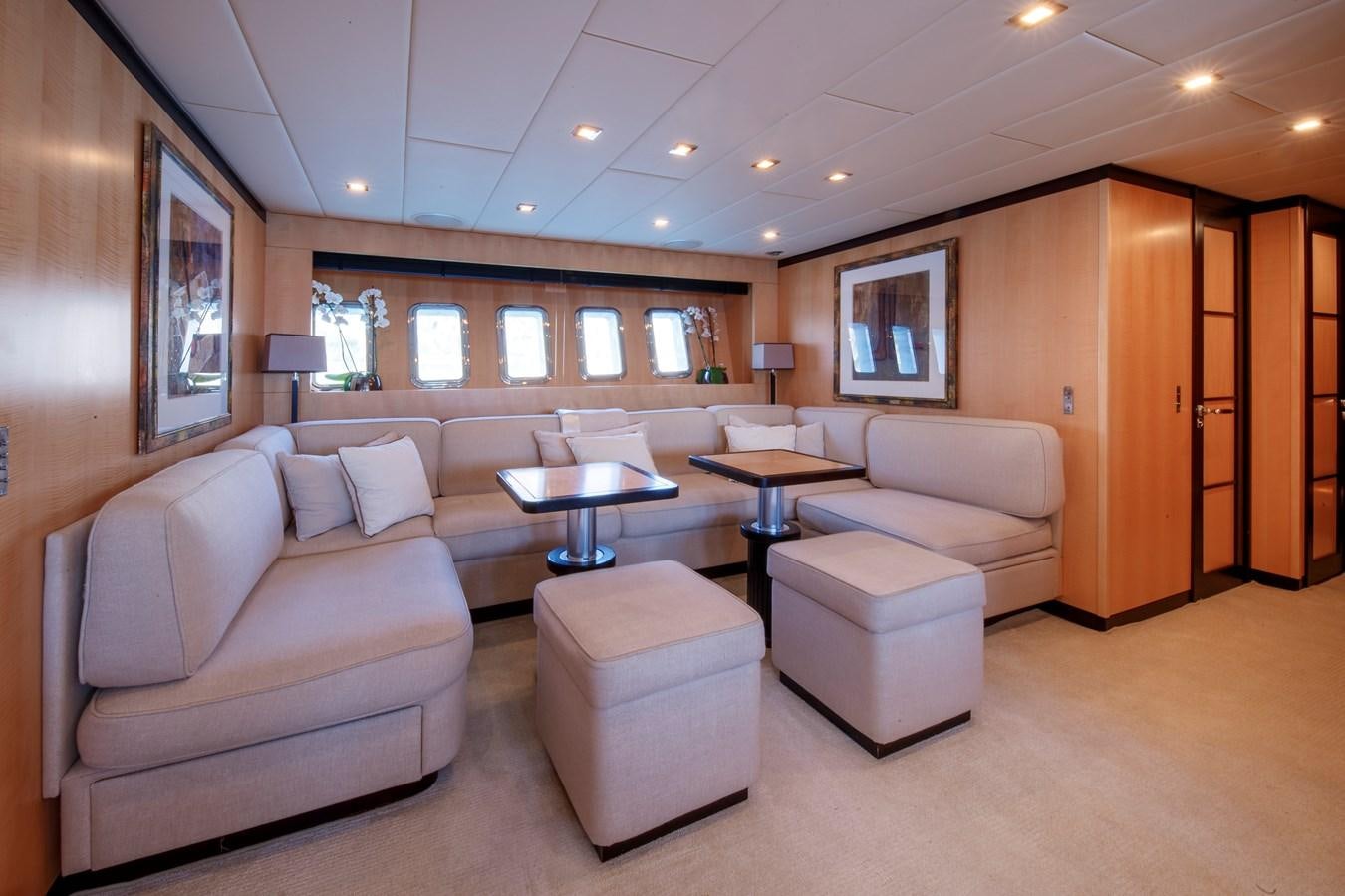 a living room with a couch and a table aboard ULTIMA BEACH Yacht for Sale