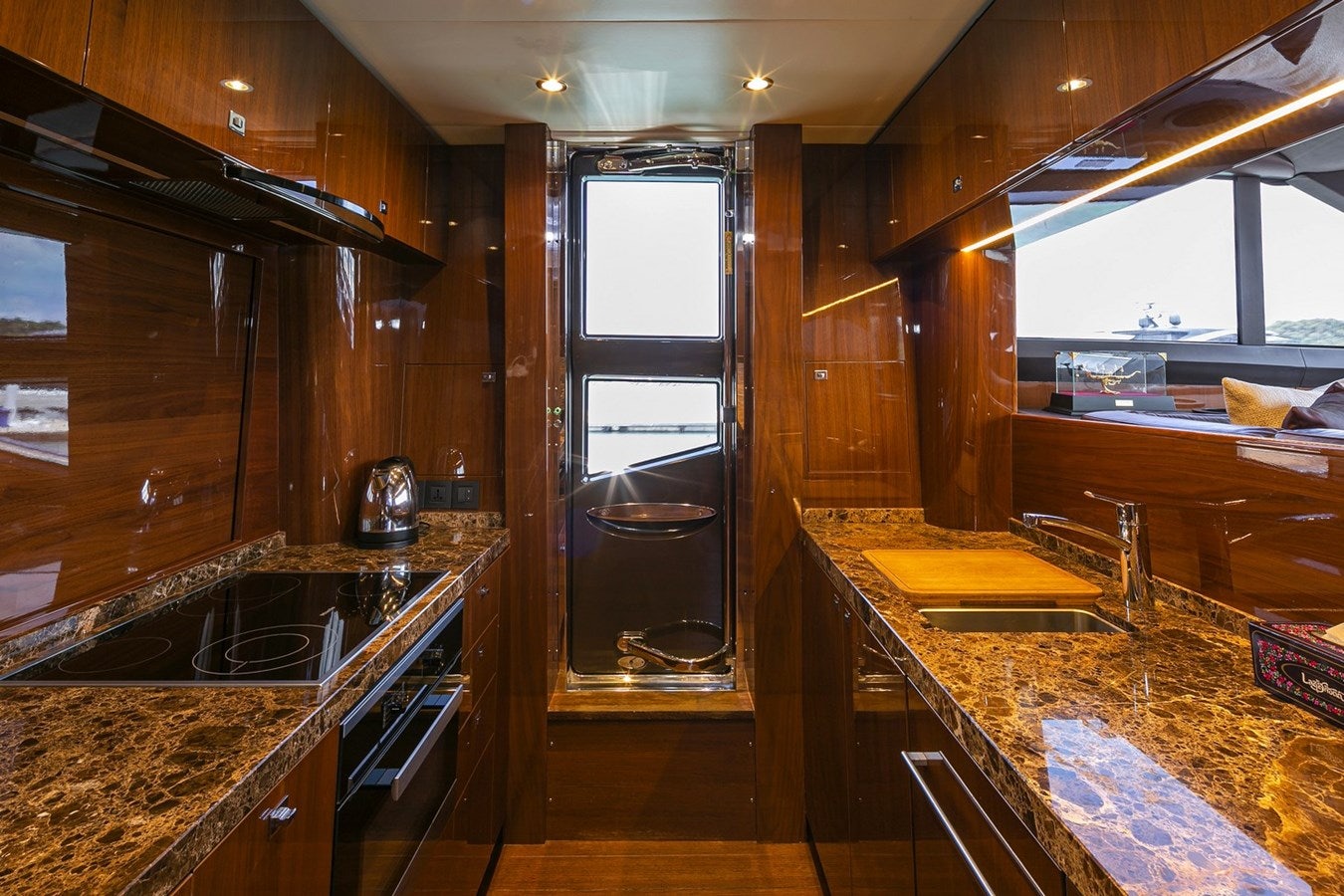 a kitchen with wooden cabinets aboard SE1 Yacht for Sale