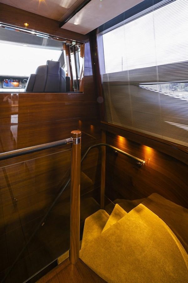 a wooden staircase with a window aboard SE1 Yacht for Sale