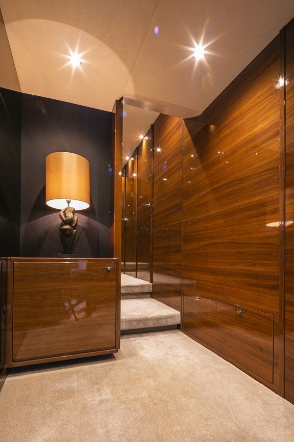 a room with a large mirror and a wood cabinet aboard SE1 Yacht for Sale