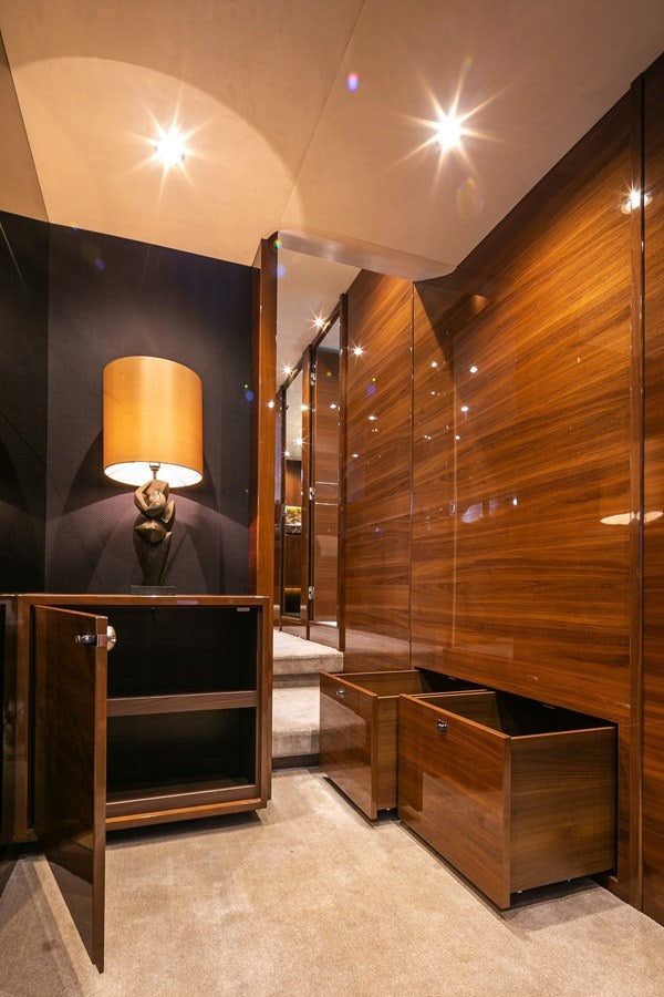 a room with a lamp and a wood cabinet aboard SE1 Yacht for Sale