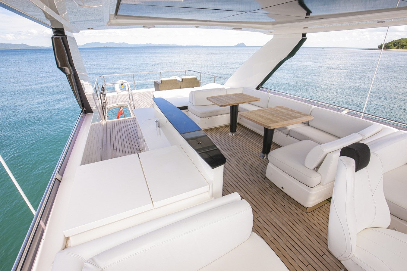 a deck with a pool and chairs aboard SE1 Yacht for Sale