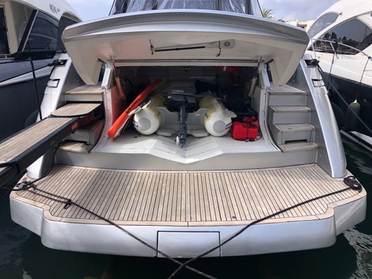 a white boat with a black and red object in the front aboard HOLY SHIT Yacht for Sale
