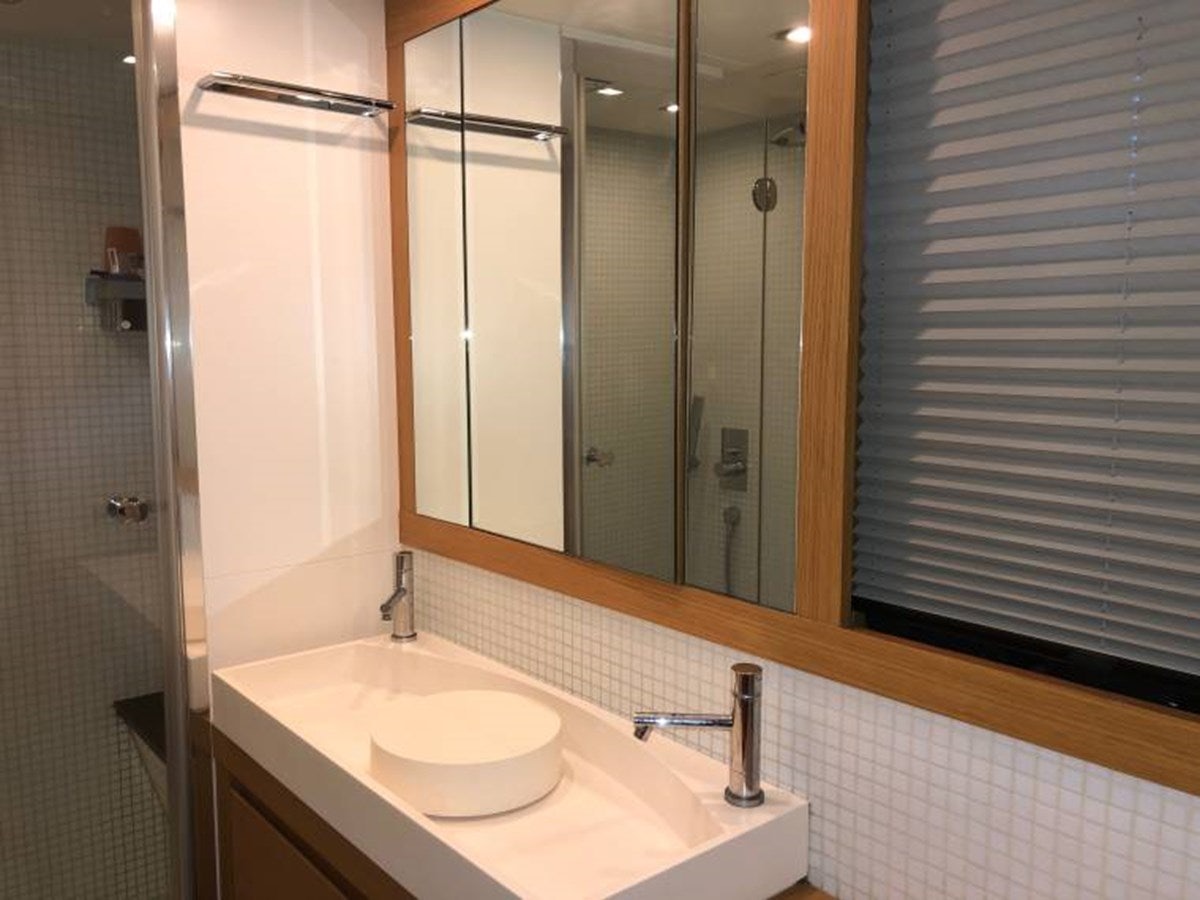 a bathroom with a sink and a mirror aboard HOLY SHIT Yacht for Sale