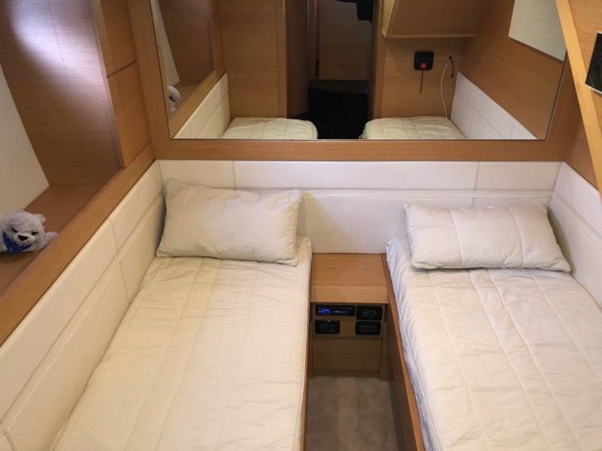a room with a bed and a mirror aboard HOLY SHIT Yacht for Sale