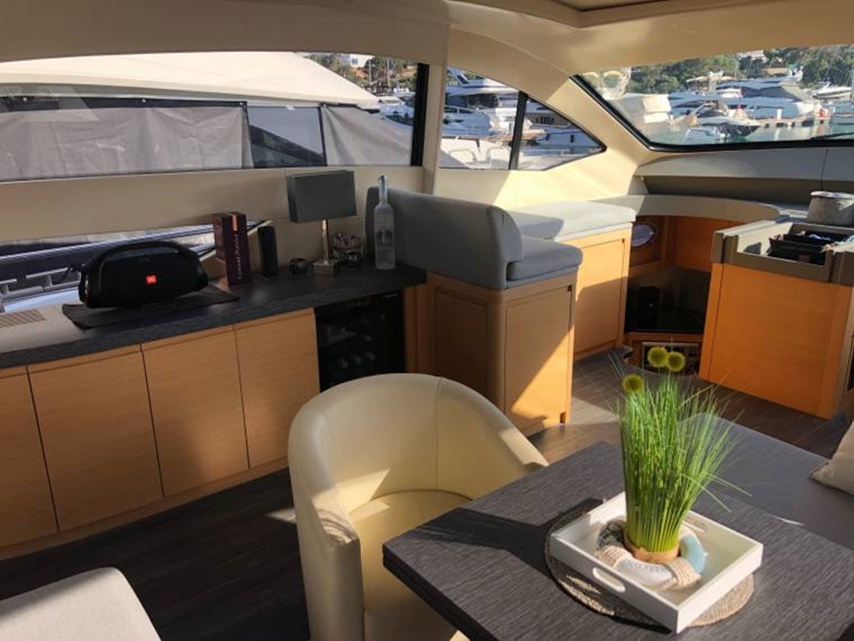 a room with a plant and a desk with a computer on it aboard HOLY SHIT Yacht for Sale