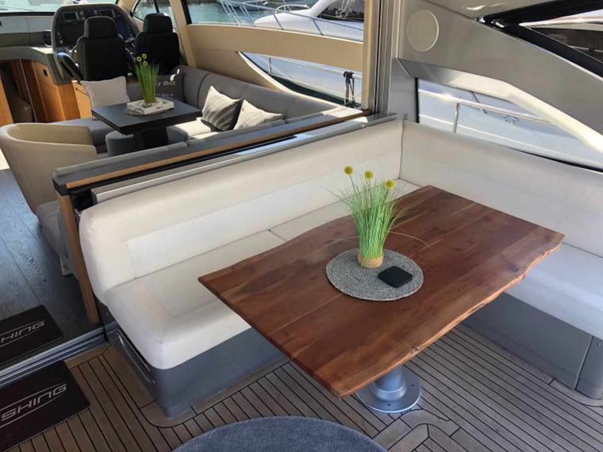 a coffee table with a plant on it aboard HOLY SHIT Yacht for Sale