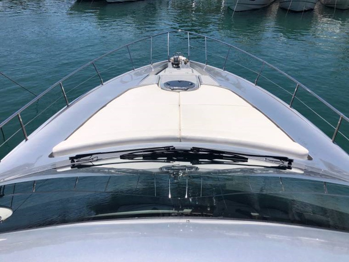 a white boat in a pool aboard HOLY SHIT Yacht for Sale