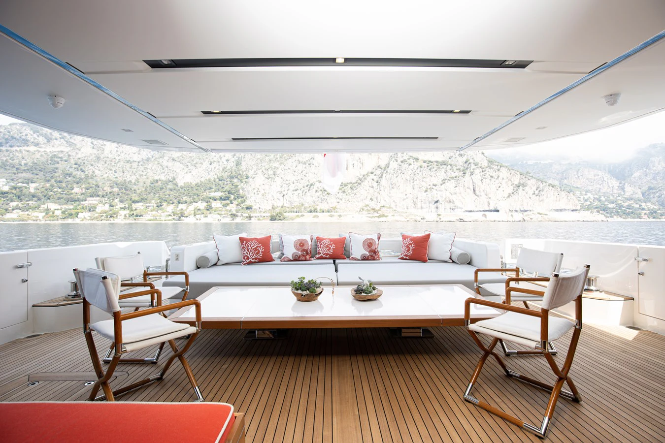 a room with a couch and a table and chairs aboard THE GREAT ESCAPE Yacht for Charter