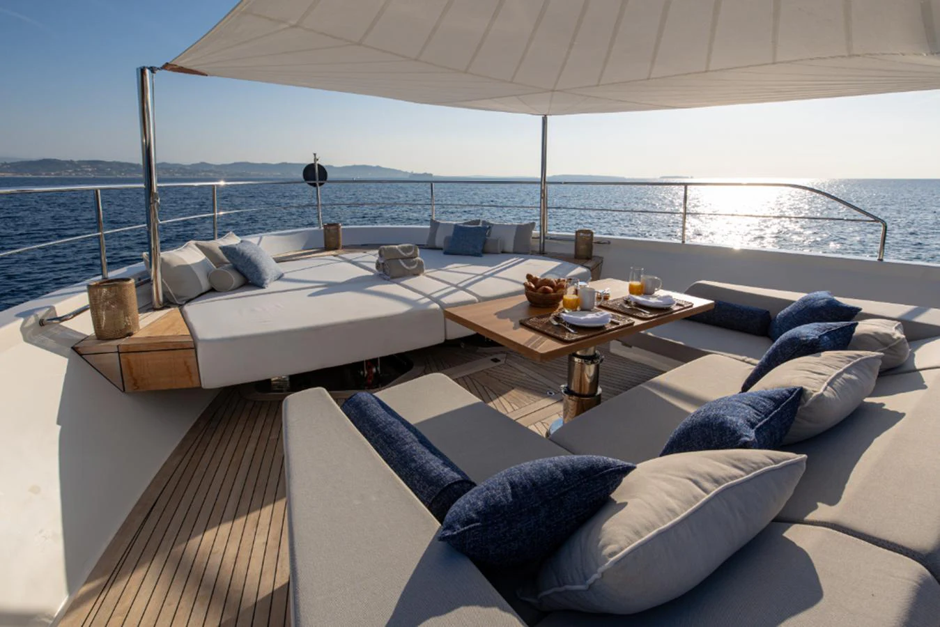 a large white bed with a table on it aboard THE GREAT ESCAPE Yacht for Sale