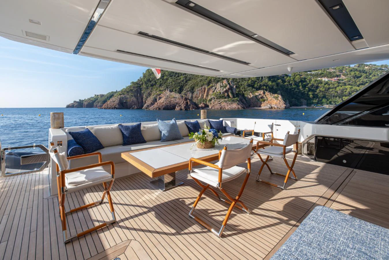 a patio with a table and chairs on it aboard THE GREAT ESCAPE Yacht for Sale