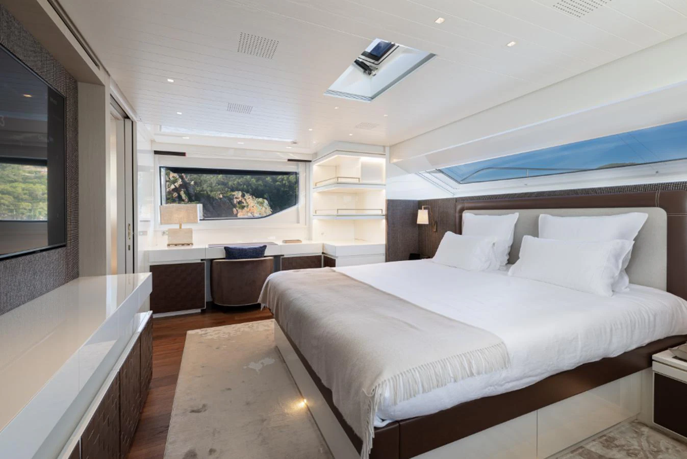 a bedroom with a bed and a desk aboard THE GREAT ESCAPE Yacht for Sale