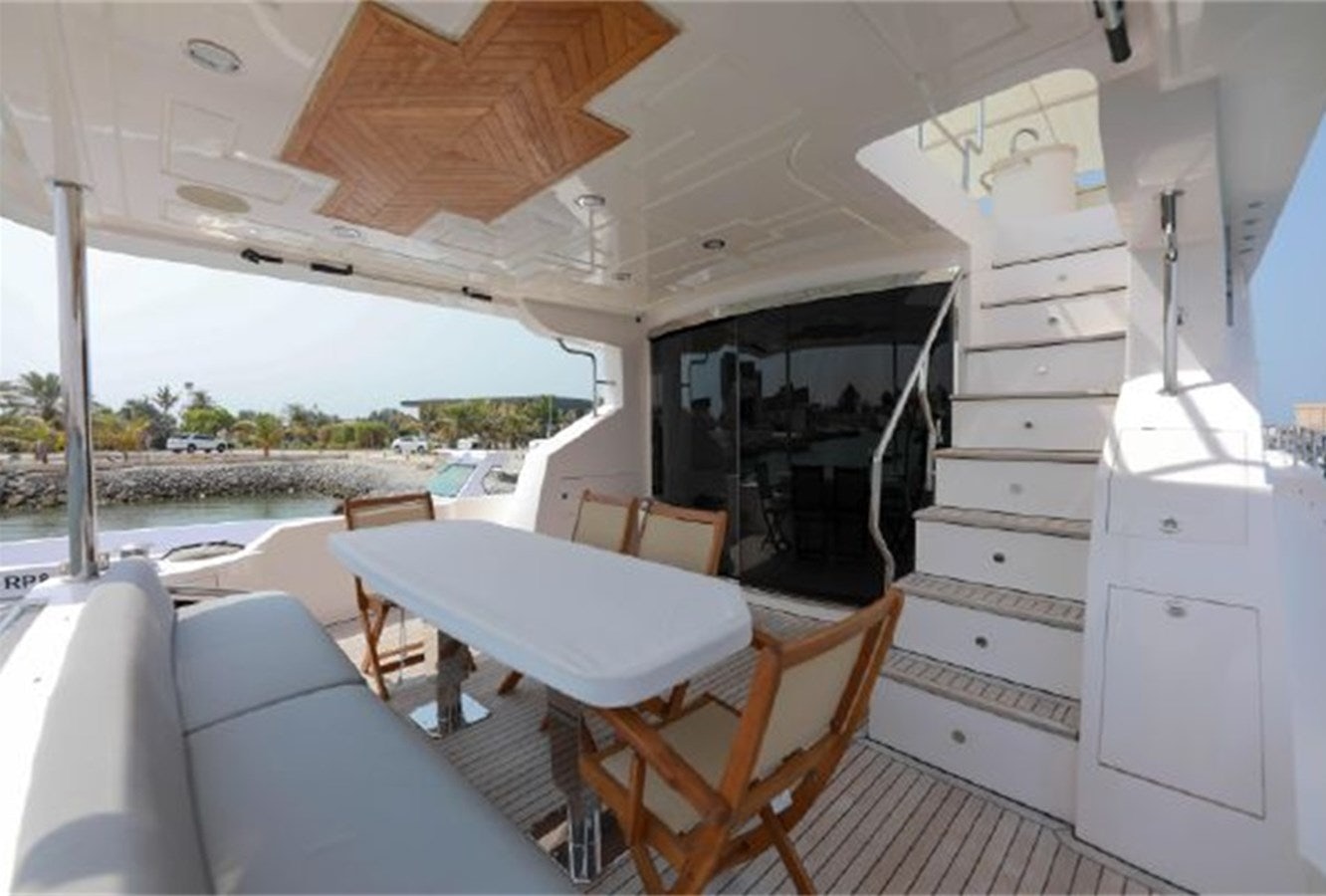 a room with a table and chairs aboard MAJESTY 70 Yacht for Sale