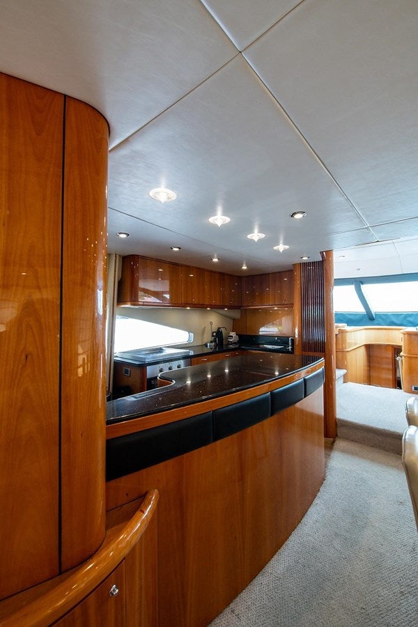 a kitchen with wooden cabinets aboard 82 SUNSEEKER MANHATTAN  Yacht for Sale